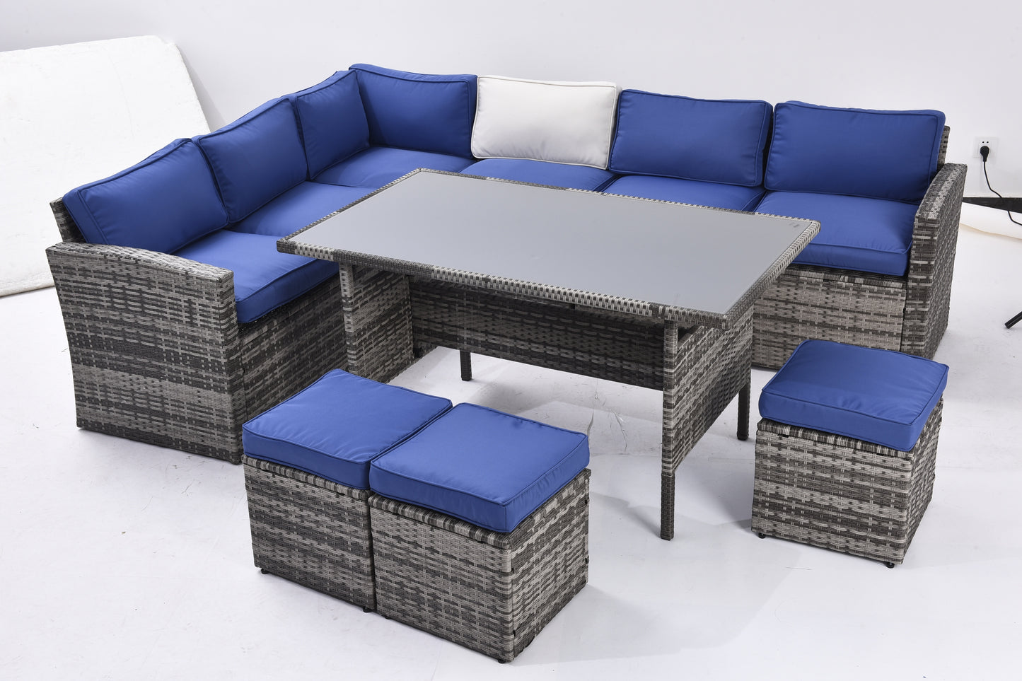 7-piece outdoor sectional sofa set with dining table, grey rattan, blue cushions